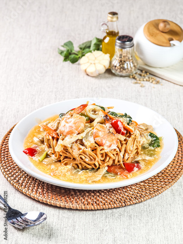 Indonesian chicken soup with noodles, turmeric and ginger (Soto Ayam). Indonesian beef noodles soup (Mie kocok). Seafood Fried Noodles (Mie Goreng - Malay style stir-fried noodles with spicy seafood.