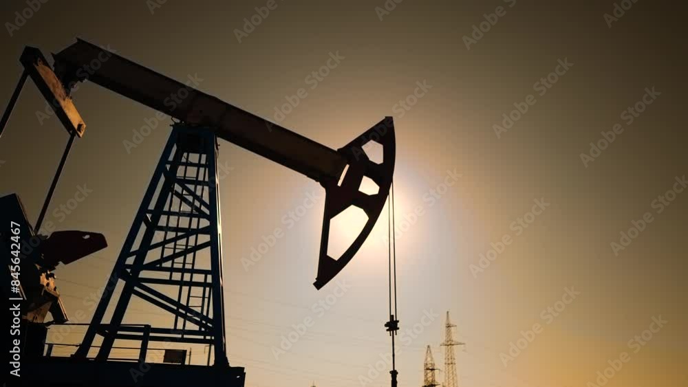 oil industry. silhouette of an oil pump extracts lifestyle oil and gas from ground of the field. business industry concept. pump pumps oil and gas at sunset. drill petroleum middle sunlight industry oil industry. silhouette of an oil pump extracts lifestyle oil and gas from ground of the field. business industry concept. pump pumps oil and gas at sunset. drill petroleum middle sunlight industry