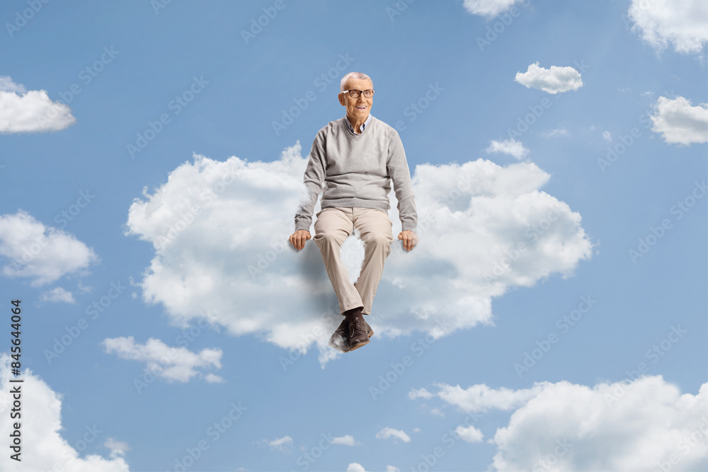 Cheerful elderly man floating on a cloud Cheerful elderly man floating on a cloud