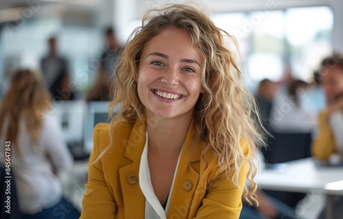 Smiling Woman in Yellow Blazer Working at Office Desk