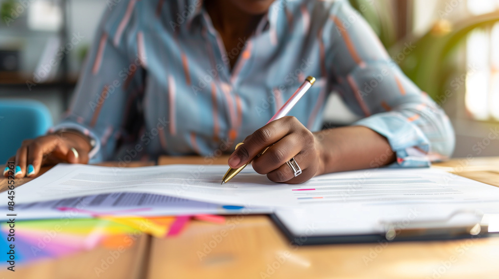 A creative professional working on documents in a colorful and vibrant office, highlighting creativity and productivity in a professional setting. A creative professional working on documents in a colorful and vibrant office, highlighting creativity and productivity in a professional setting.