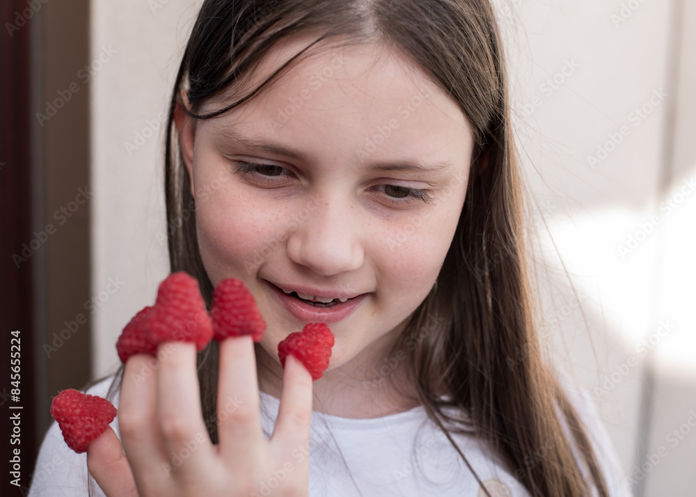 The girl put raspberries on her fingers. Girl spoils herself with a hand that has raspberries on her fingers. Girl with Raspberries on Her Fingers The girl put raspberries on her fingers. Girl spoils herself with a hand that has raspberries on her fingers. Girl with Raspberries on Her Fingers