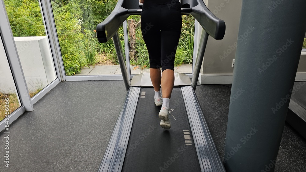 Woman Running on Treadmill in Gym Woman Running on Treadmill in Gym