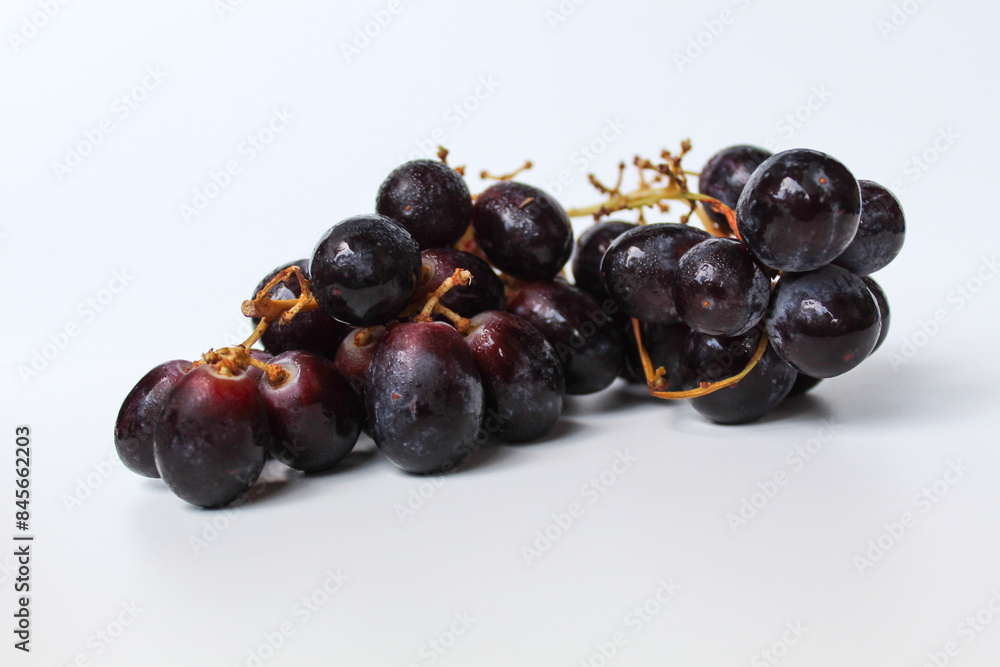 Dark purple grape with stem, isolated on white background Dark purple grape with stem, isolated on white background