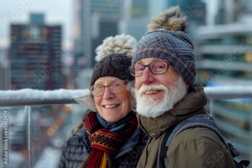 Portrait of a content couple in their 60s dressed in a warm ski hat in front of modern cityscape background