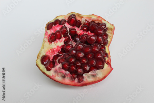 Inside of pomegranate fruit, fresh red seeds, isolated on white background