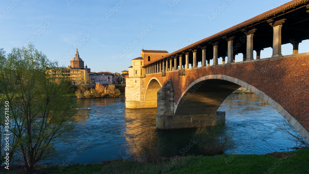 Landscape of Ponte Coperto (covered bridge) and Duomo di Pavia (Pavia Cathedral) in Pavia at sunny day, Lombardy, italy. Landscape of Ponte Coperto (covered bridge) and Duomo di Pavia (Pavia Cathedral) in Pavia at sunny day, Lombardy, italy.