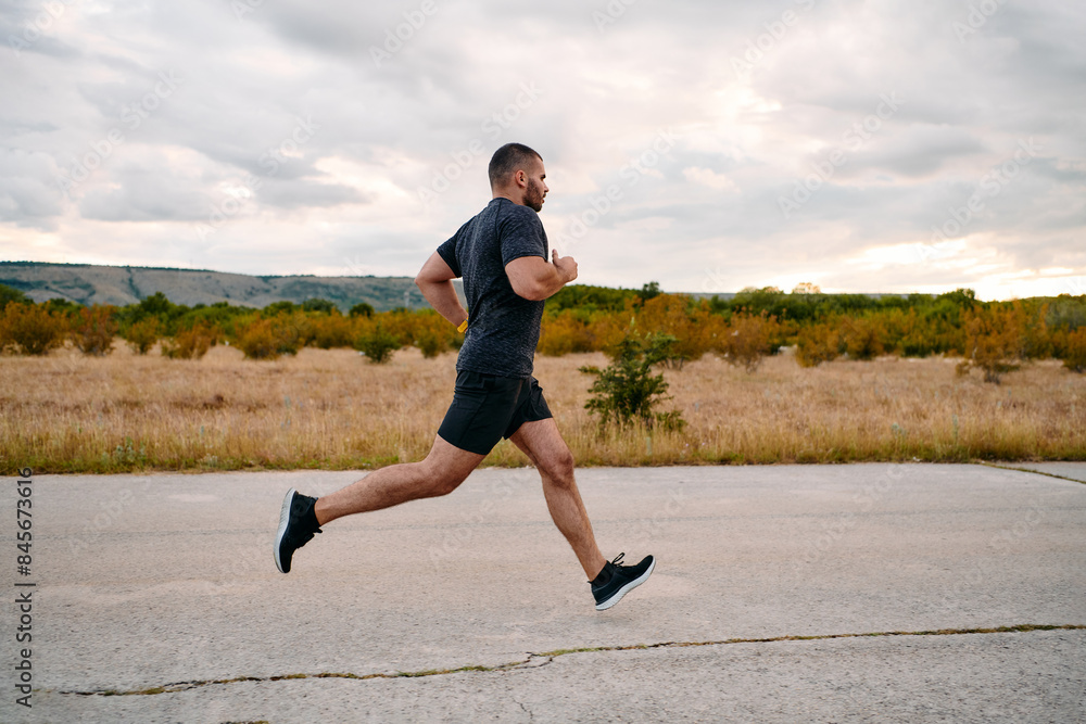 Athletic Man Jogging in the Sun, Preparing His Body for Life's Extreme Challenges Athletic Man Jogging in the Sun, Preparing His Body for Life's Extreme Challenges