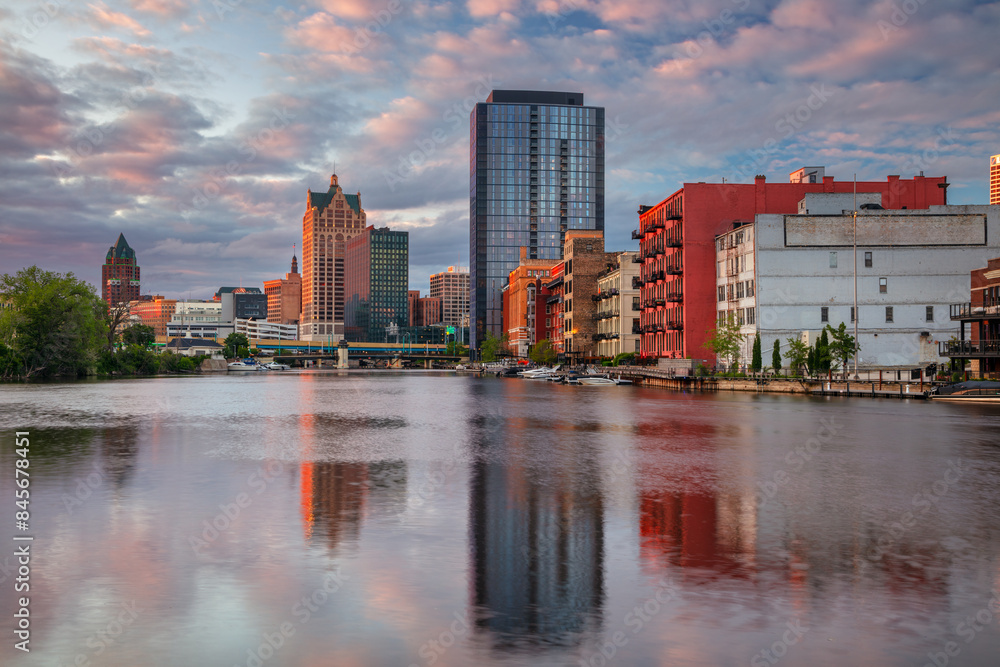 Milwaukee, Wisconsin, USA. Cityscape image of downtown Milwaukee, Wisconsin, USA with reflection of the skyline in Mnemonee River at summer sunset.