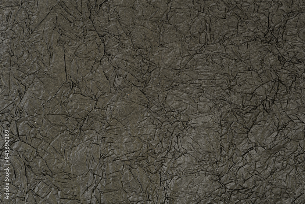 Fototapeta premium Crumpled matte black paper. Abstrack background, wallpaper. Dark minimalistic background