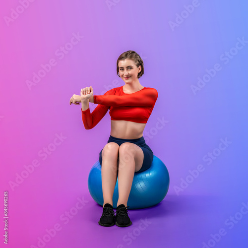 Full body length gaiety shot athletic and sporty young woman with fitness exercising ball in standing posture on isolated background. Healthy active and body care lifestyle.