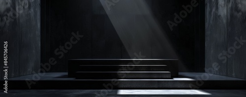 Dark room with black glass podium illuminated by a shaft of light