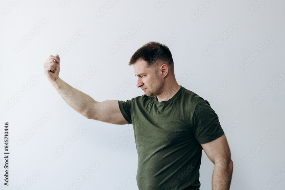 Strong man shows off pumped up biceps arms. Strong man shows off pumped up biceps arms.