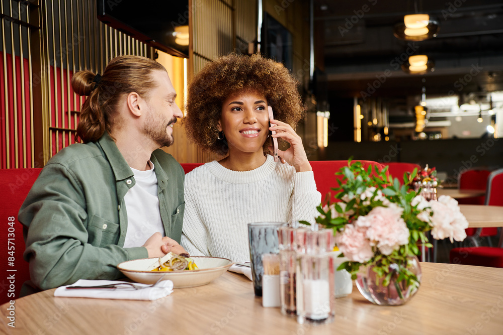 An African American woman and a man at a modern cafe table An African American woman and a man at a modern cafe table
