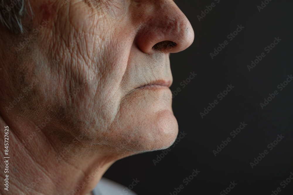 Fototapeta premium Portrait of a man with a serious expression, dark background