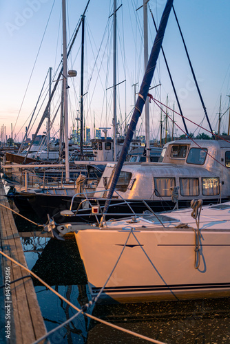 Helsinki, Finland - May 26th 2024: A lot of yachts parked in a harbour. Nighttime summer view with the sun still shining from behind the horizon.
