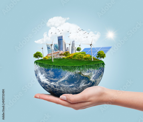 Environmental concept with hand holding planet earth showing sustainable and eco-friendly renewable energy
