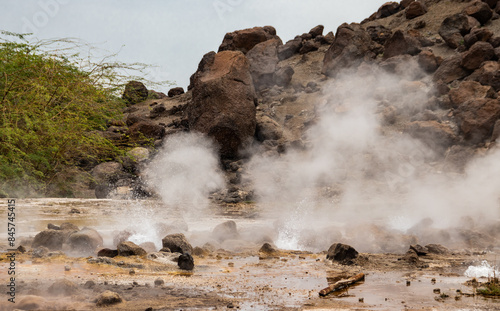 Alolabad geothermal area in Ethiopia with surreal landscape of colorful hot springs, steaming fumaroles, and erupting salt geysers in an arid, remote desert setting below sea level, Afar desert photo