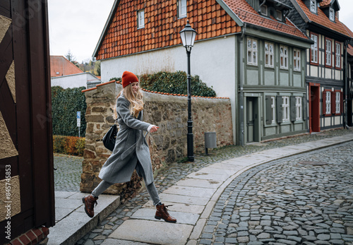 a young girl walks through the old cities of Europe #845745853