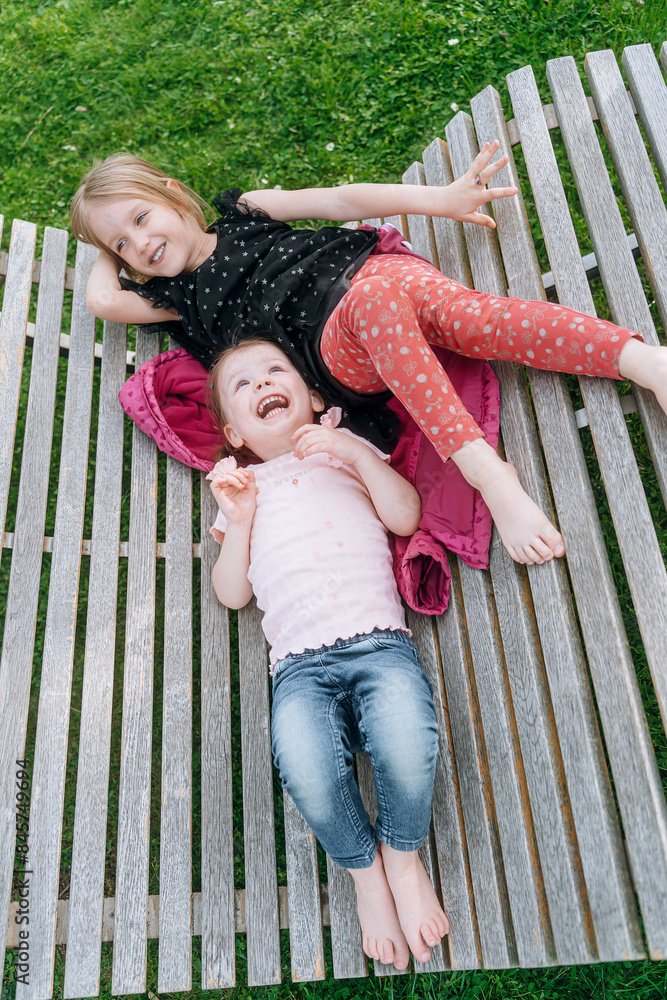 Fototapeta premium two little girls friends spend time together in the park