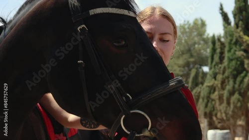 Portrait closeup happy young woman hugs her horse with love affection care, Girl jockey hand hold muzle horse pet photo