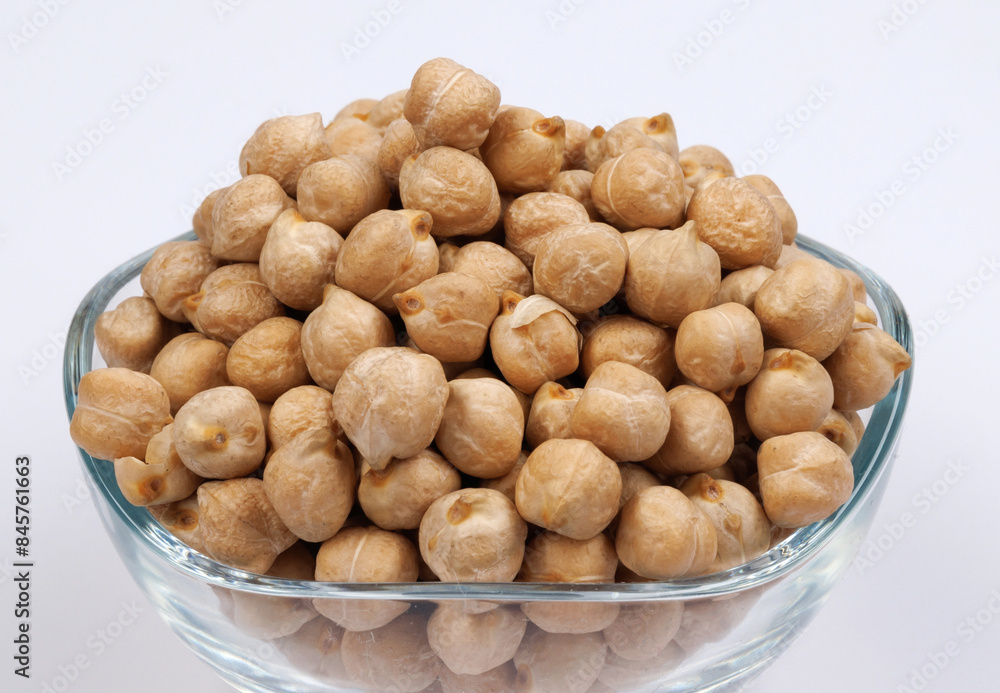 Glass bowl full of chickpeas on white background. Glass bowl full of chickpeas on white background.