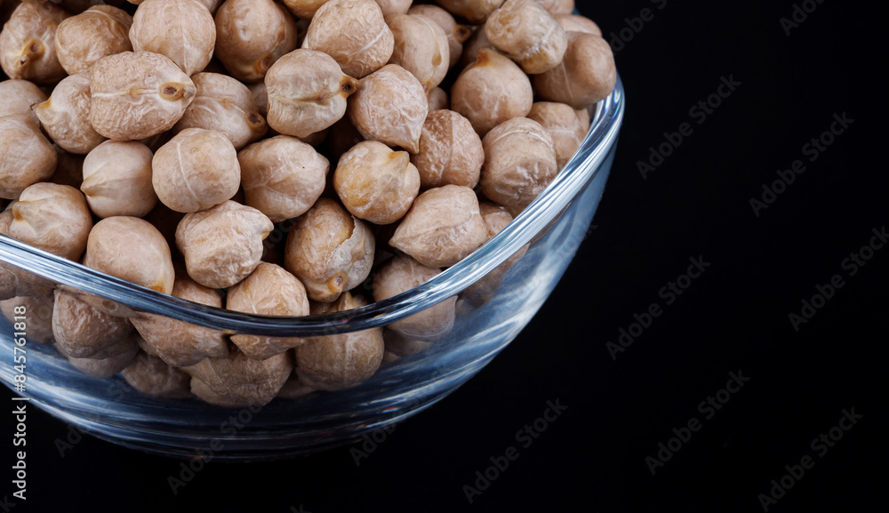 Glass cup with chickpeas on a dark background. Glass cup with chickpeas on a dark background.