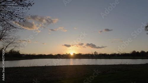 Pan up over lakeside homes to reaveal beautiful spring Sunset photo