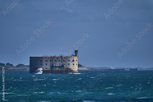 ancient Fort Boyard along the coastline of the atlantic ocean of Oleron Island during summer with turquoise ocean and scenic clouds.