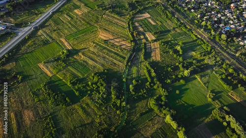aerial country side landscape harvest fields park and trees green environment outskirts space in end of summer season August month time evening contrast lighting with shadow from sun © Артём Князь