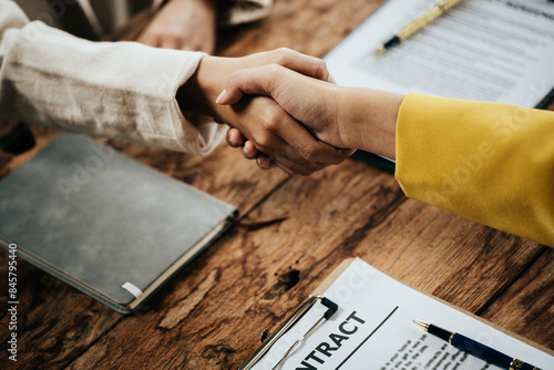 Obraz na plátne Close up of hands Lawyers explain and discuss matters of law then shakehands after and dealing contract agreement to clients discuss for prepare for the trial