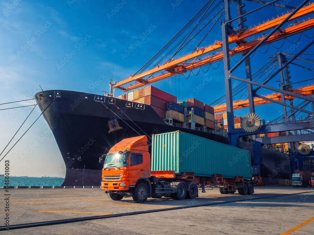Naklejka premium The container vessel during discharging at an industrial port and move containers