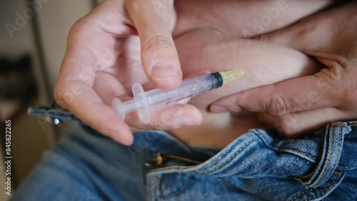 Woman injecting progesterone into her belly for fertility treatment, focusing on assisted reproduction, gynecology, and reproduction photo