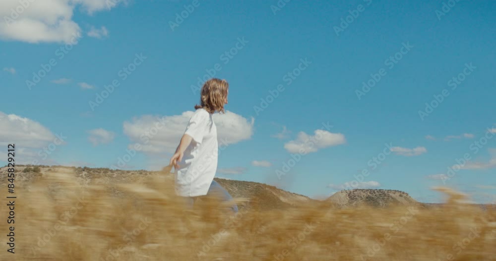 Freedom lover female adventurer, young woman run in field of wheat, happy and carefree in summer mood. Summertime happiness exploring nature and being outdoors Freedom lover female adventurer, young woman run in field of wheat, happy and carefree in summer mood. Summertime happiness exploring nature and being outdoors
