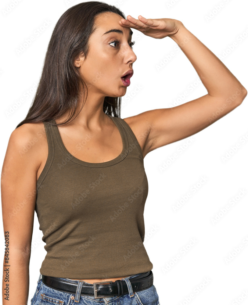 Hispanic young woman looking far away keeping hand on forehead. Hispanic young woman looking far away keeping hand on forehead.