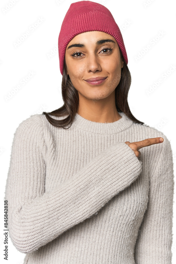 Hispanic young woman smiling and pointing aside, showing something at blank space. Hispanic young woman smiling and pointing aside, showing something at blank space.