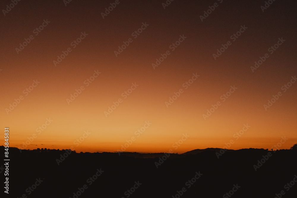 Fototapeta premium landscape view of orange sunset in the countryside
