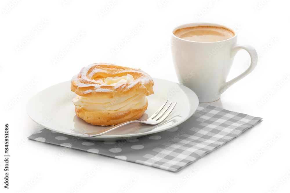 A cream puff on a white plate, a cup of coffee and a napkin. Isolate on a white background