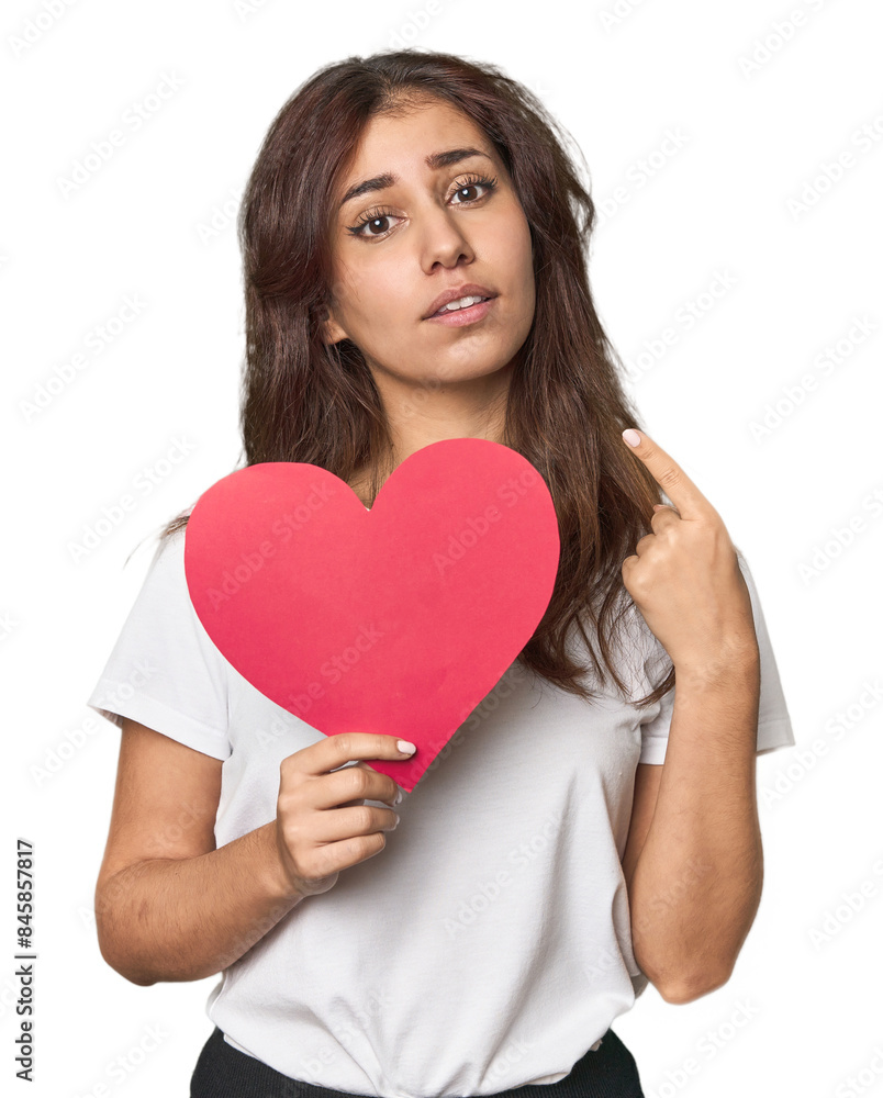Middle Eastern woman holding paper heart pointing with finger at you as if inviting come closer. Middle Eastern woman holding paper heart pointing with finger at you as if inviting come closer.