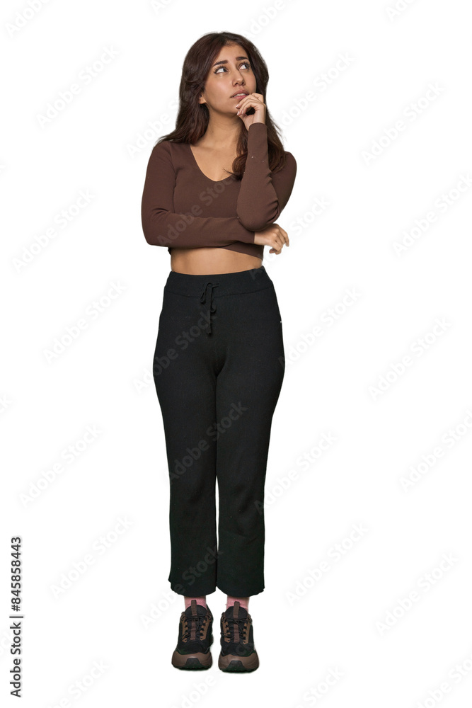 Middle Eastern woman, full body studio relaxed thinking about something looking at a copy space. Middle Eastern woman, full body studio relaxed thinking about something looking at a copy space.