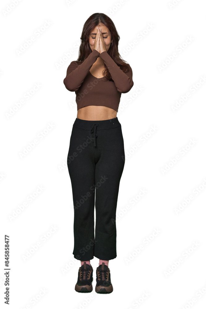 Middle Eastern woman, full body studio holding hands in pray near mouth, feels confident. Middle Eastern woman, full body studio holding hands in pray near mouth, feels confident.