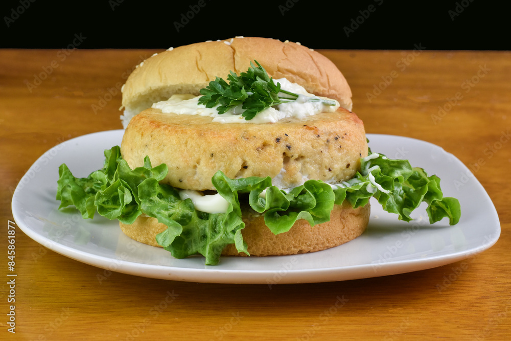 salmon burger top with tarter sauce and parsley salmon burger top with tarter sauce and parsley