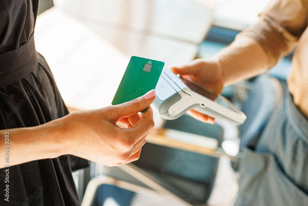 NFC credit card payment. Woman paying with contactless credit card with NFC NFC credit card payment. Woman paying with contactless credit card with NFC