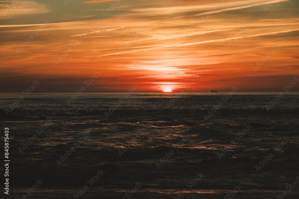 Sunset in the ocean by the lighthouse Sunset in the ocean by the lighthouse