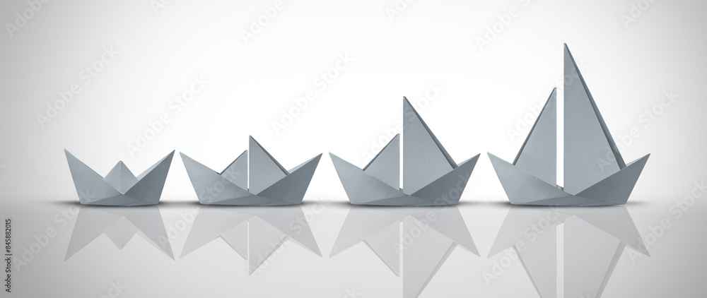 Business Development Concept and growth strategy or corporate model innovation as a motivational metaphor for growing success from simple to complex as origami boats. Business Development Concept and growth strategy or corporate model innovation as a motivational metaphor for growing success from simple to complex as origami boats.