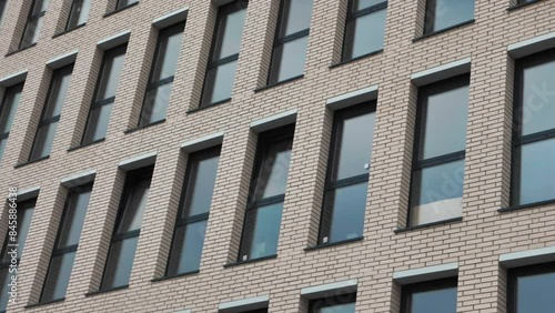 Panorama of Facade Multi-apartment new Building witn many windows. Slow motion.  photo