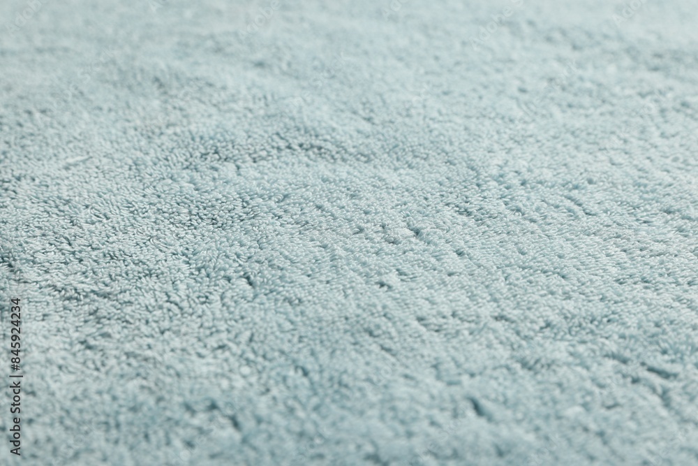 Obraz premium Soft light blue towel as background, closeup