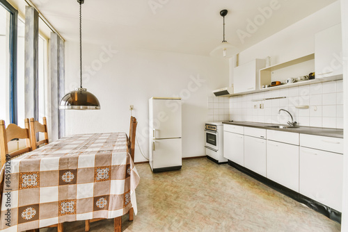 Vintage kitchen interior with checkered tablecloth photo