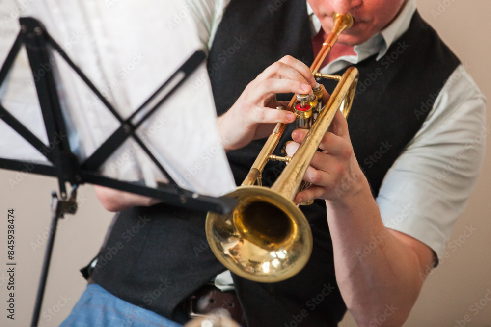 Naklejka premium Trumpet player. A brass instrument commonly used in classical and jazz music