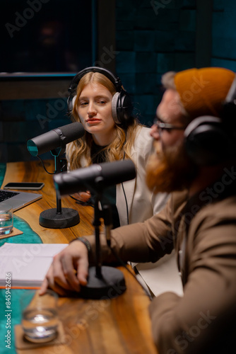 Obraz na płótnie Two young stylish radio show hosts record fresh podcast episode in home loft stu